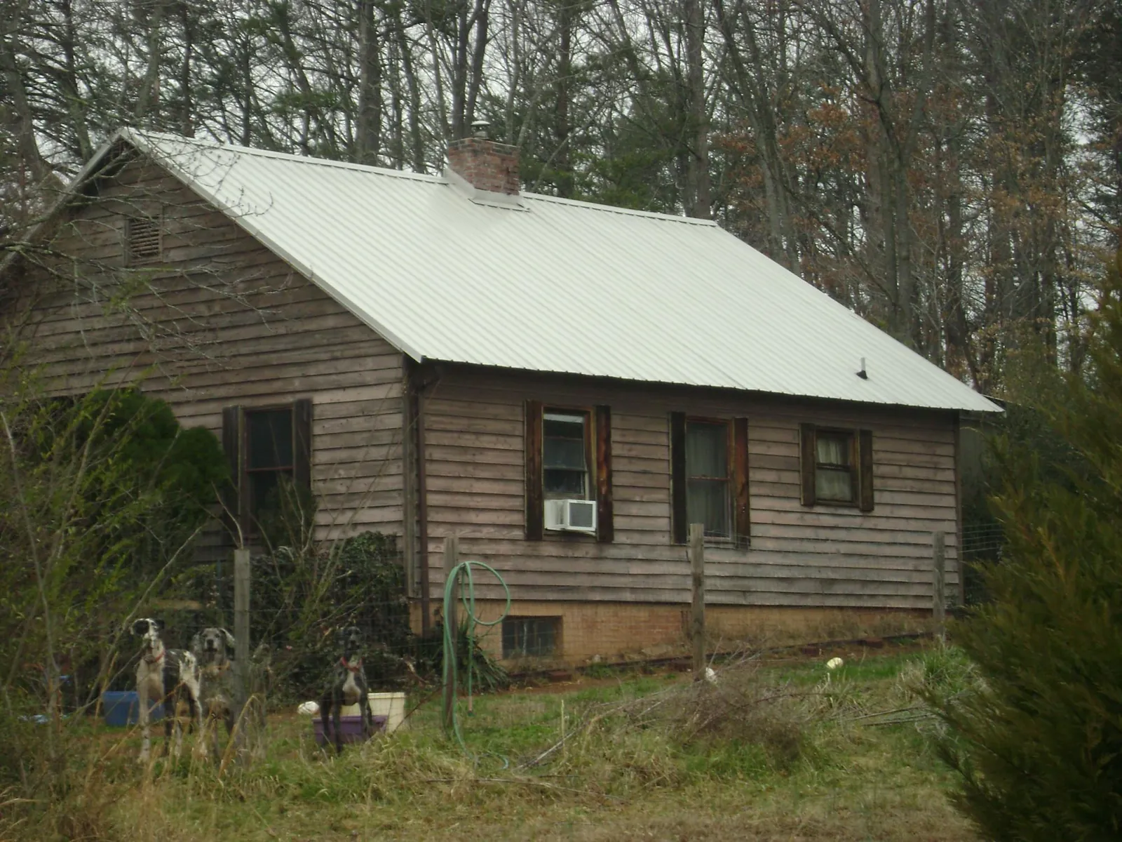 White metal roof on an old wood sided farmhouse, from a Metal Roof Installation job in Litchville